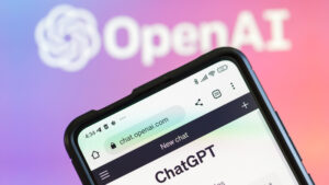 A phone displays ChatGPT with OpenAI in the background